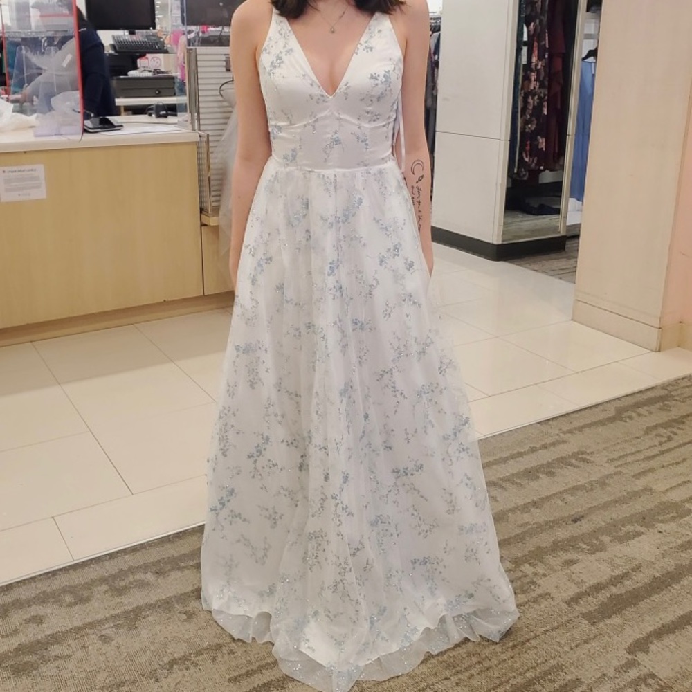 This is a beautiful white with blue sparkly dress! The brand is macys, size four